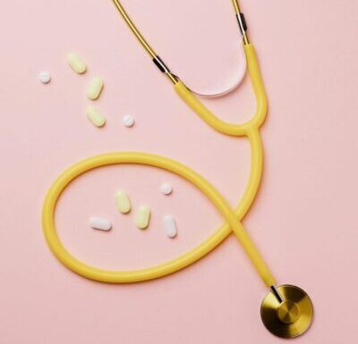 Yellow stethoscope and medicine on a colorful background